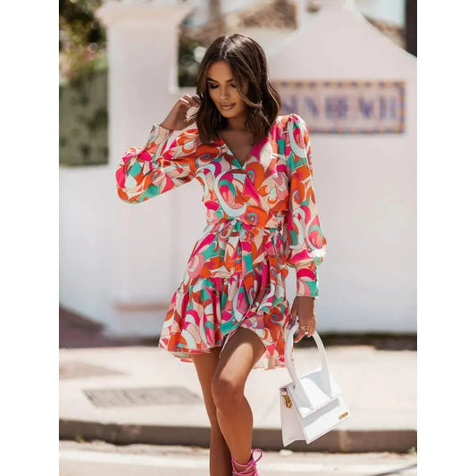 Woman wearing a colorful patterned dress with a blurred background